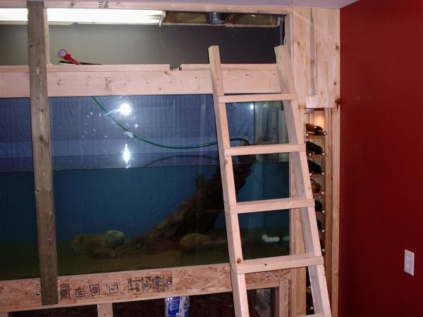 4. Approximate volume was 1200 gallon. I had some extra room on the right and built a wine rack. Our whole basement had pine accents and a deep red paint, which you'll see goes well with a slate floor and drop ceiling.